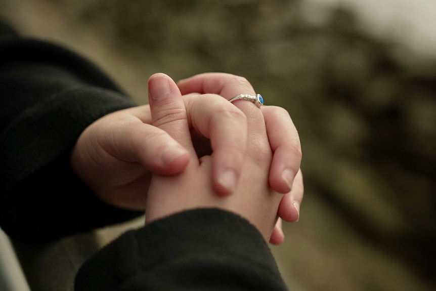 A close up of a woman's hands which are clasped together.