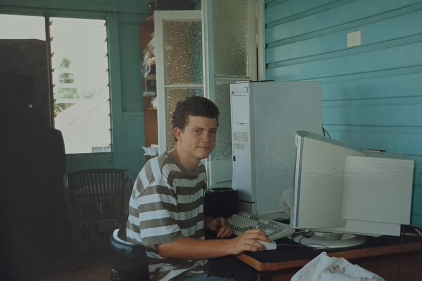Chris Wade as a teenager in front of a computer.