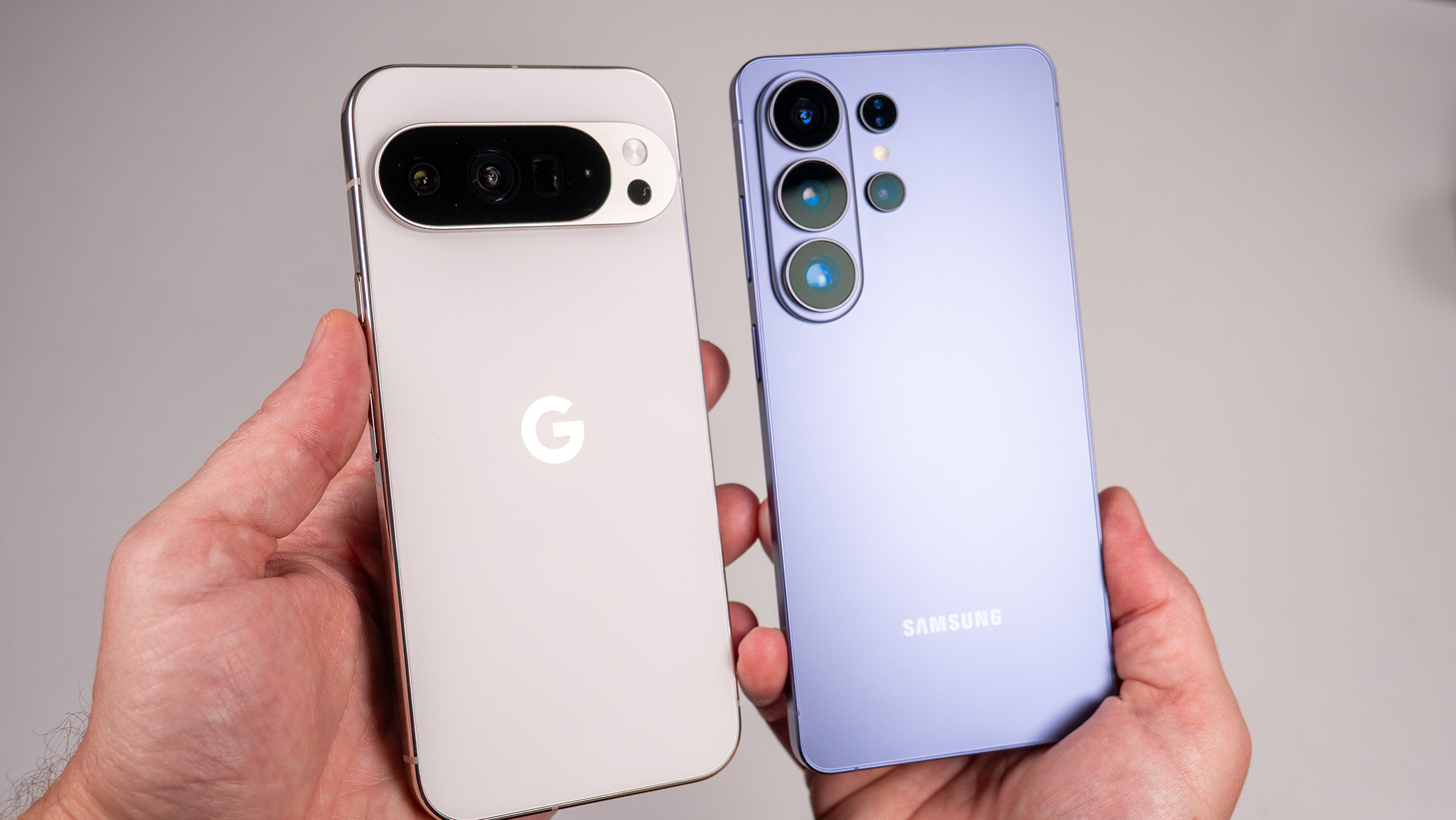 Comparing the back of the white Google Pixel 10 Pro XL with the blue Samsung Galaxy S26 Ultra