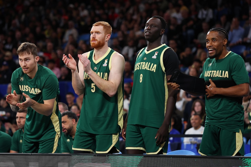 Reyene Smith, Angus Glover, Wani Swaka Lo Buluk and Bryce Cotton on the sidelines of a Boomers game.