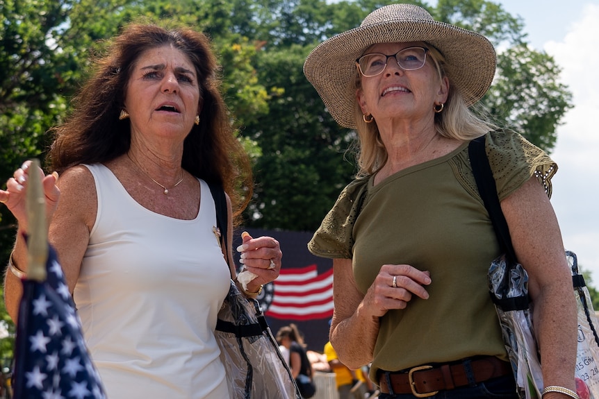 Two women stand and chat at the National Mall.