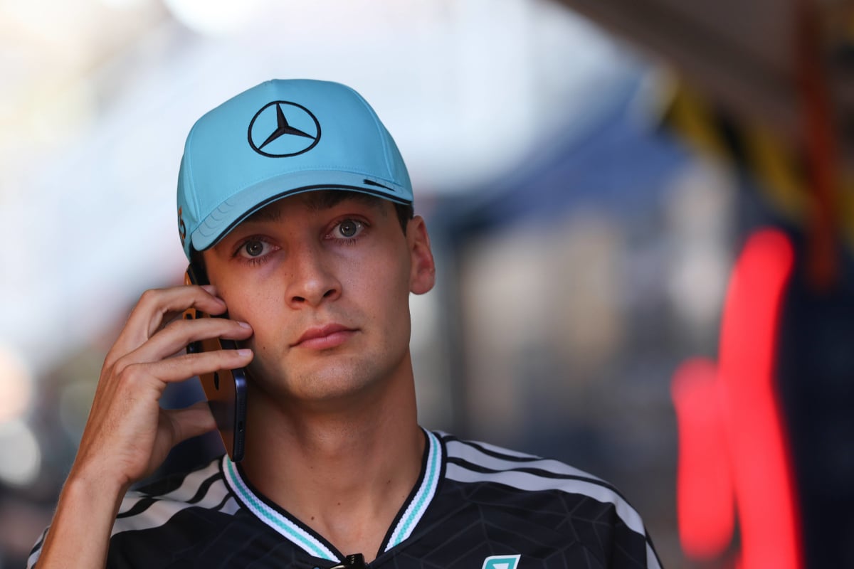 George Russell looks sad on the phone