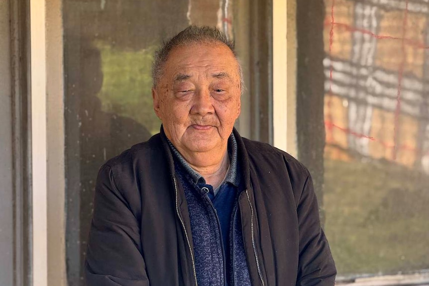 A portrait of Kwong Wan Lo wearing a black jacket.