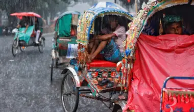 Rickshaw drivers sitting inside their rickshaws to take cover during torrential rain in Dhaka, Bangladesh, on July 7.