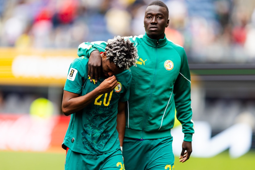 Pape Gueye consoles an upset Ibrahim Mbaye on the pitch