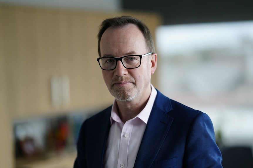 David Shoebridge wearing a navy suit jacket and white shirt.