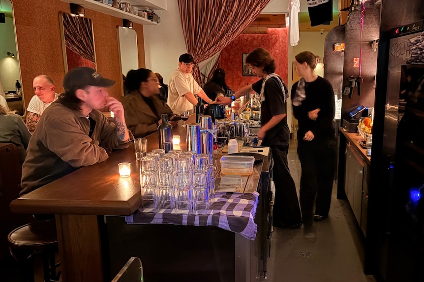 People sat at dimly lit bar