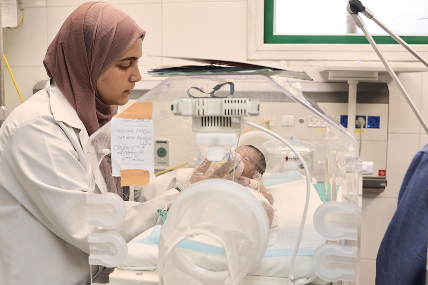 A nurse delivers care to a baby with chickenpox in a Gazan hospital.
