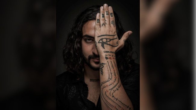 Daniel Hidden carried the coordinates of two places close to his heart inked on his hands: Mount Tochal in Iran and a secluded waterfall in Australia.