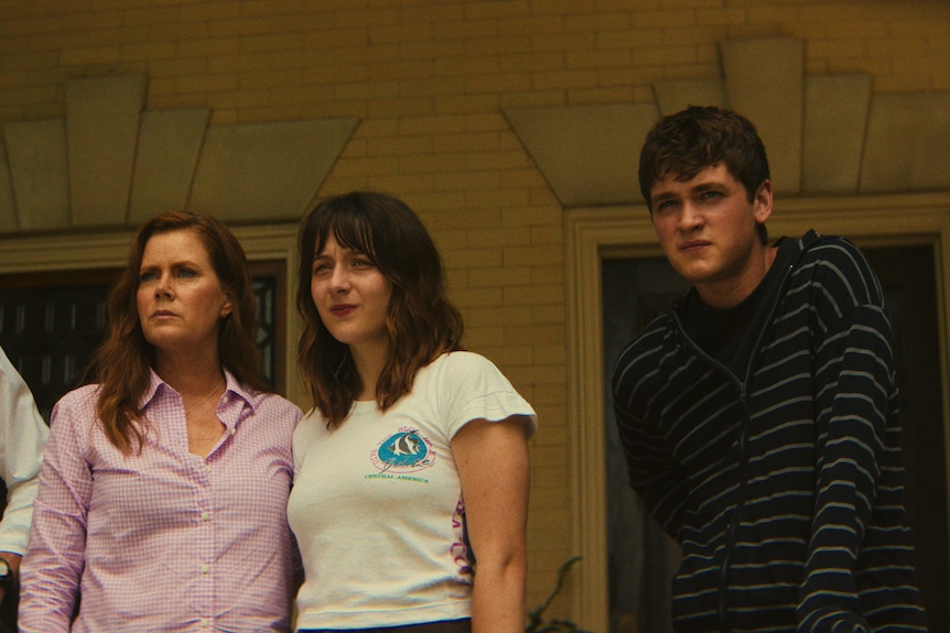 A TV still of Patrick Wilson, 53, Amy Adams, 51, Lily Collias, 20, and Joe Anders, 22, standing together concerned.