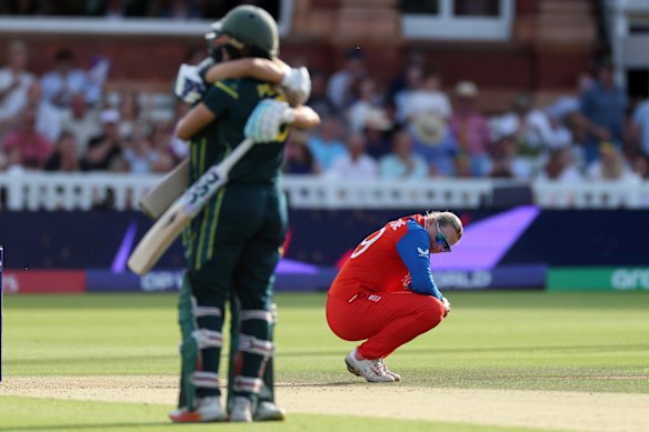 Sophie Ecclestone looks dejected as Australia’s cricketers celebrate.
