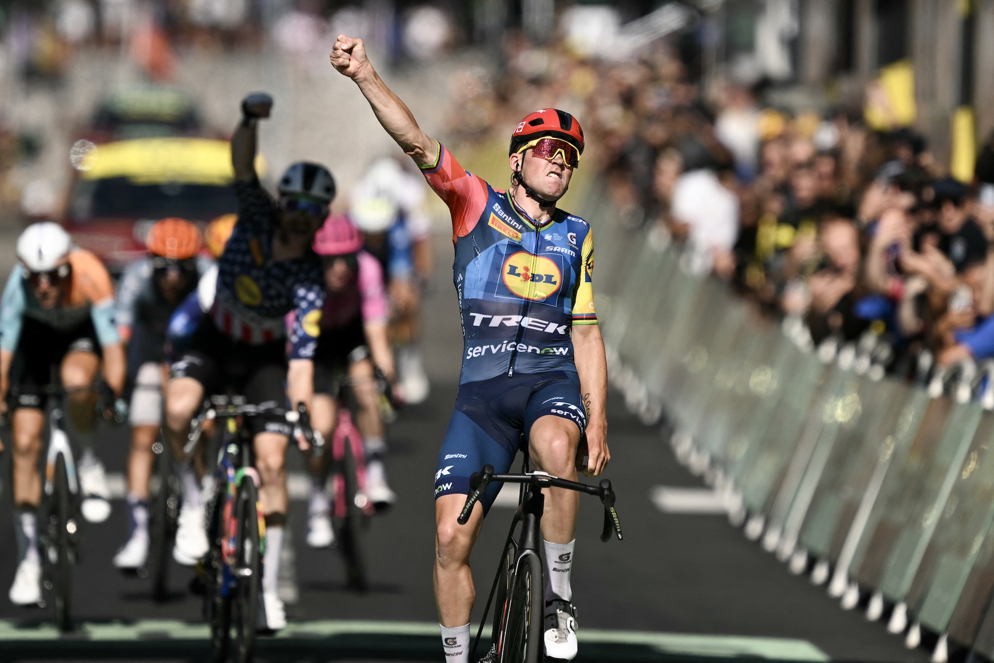 Lidl - Trek team's Danish rider Mads Pedersen celebrates as he crosses the finish line to win the 4th stage of the Tour de France (Photo by Jeff PACHOUD / AFP)