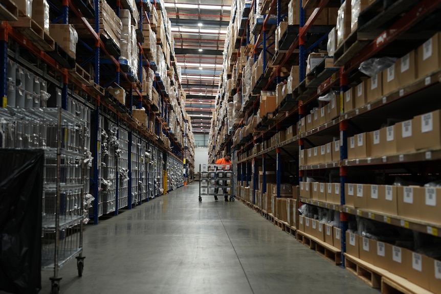 a man in a warehouse smiling