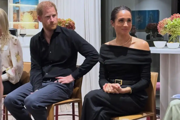 Meghan Markle and Prince Harry sitting side by side