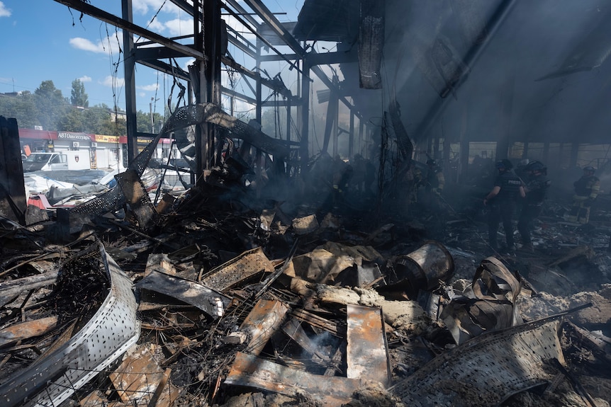Emergency workers search for victims after Russian missile hit a supermarket in Ukraine