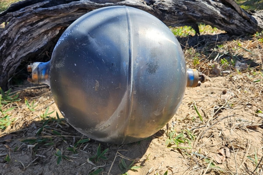 A close-up of a black metallic ball suspected to be space debris.