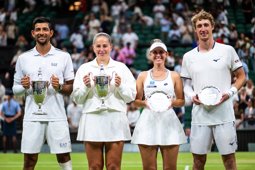 Marcelo Arevalo, Jelena Ostapenko, Storm Hunter and Marc Polmans pose with their trophies