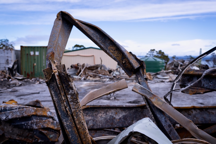 Wreckage of a residence destroyed by fire on a rural block.