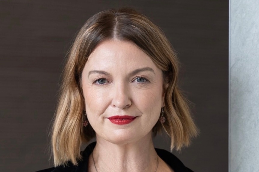 A headshot of a woman with blonde hair.