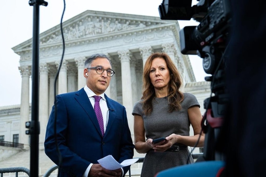 two people being interviewed by tv news