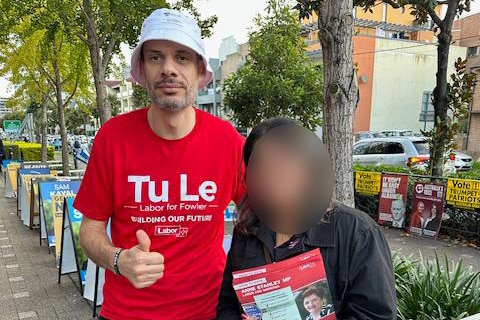 Hassan Hijazi handing out electiojn paraphernalia