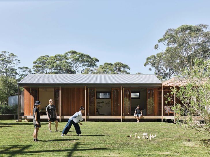 A roofed deck to the addition doubles as external circulation and a seat in the garden at Re-generation House.