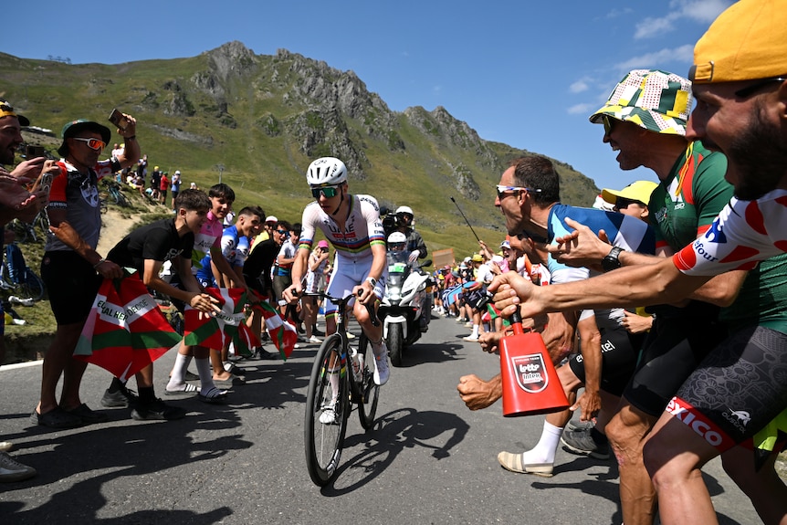 Tadej Pogačar rides through the crowd