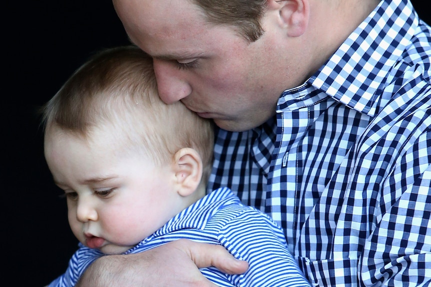 Britain's Prince William kisses his son Prince George.