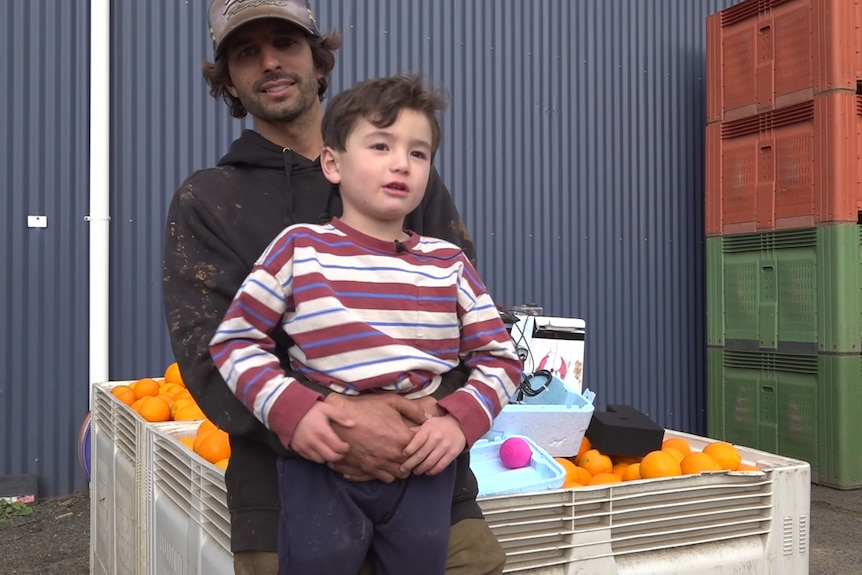 A young child sitting in his father's lap