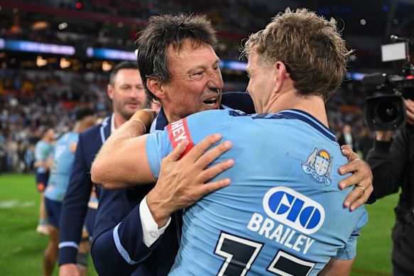Laurie Daley celebrates a remarkable Origin series win with Blayke Brailey.