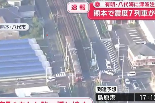 an aerial shot of a train slightly derailed after an earthquake.