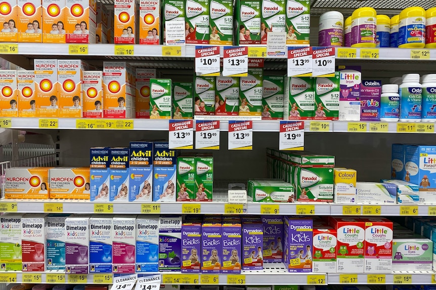A pharmacy shelf in Glebe, NSW. There's an assortment of different medications on the shelf.