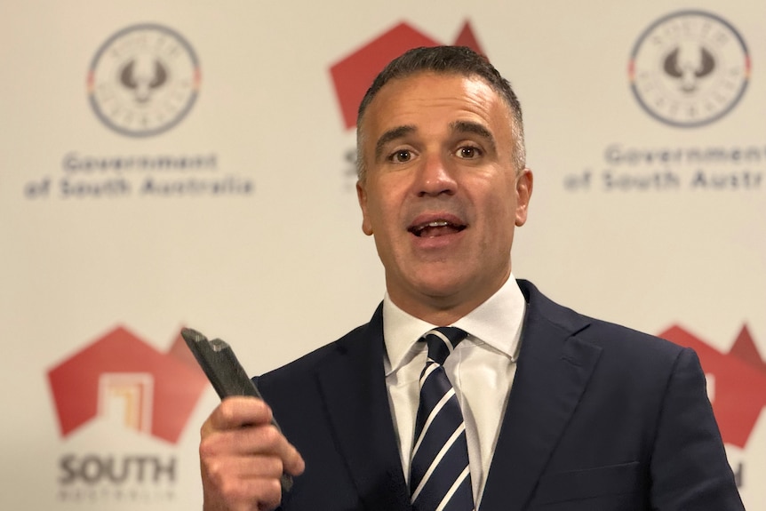 SA Premier Peter Malinauskas holding a piece of antimony.