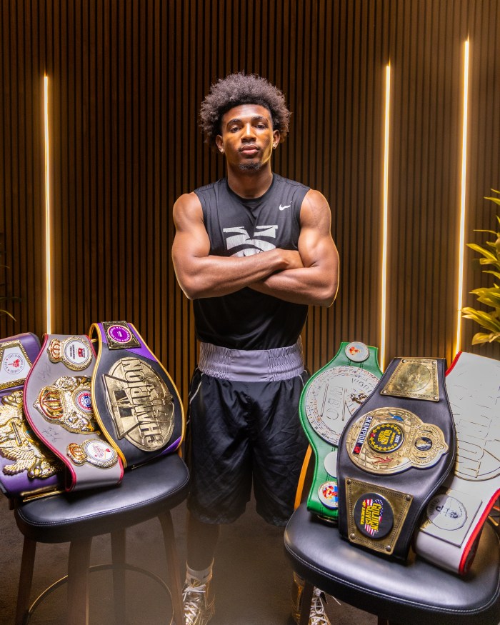 “It has given me a home within a home,”Morehouse College junior Emmanuel Seifu shows off his title belts.