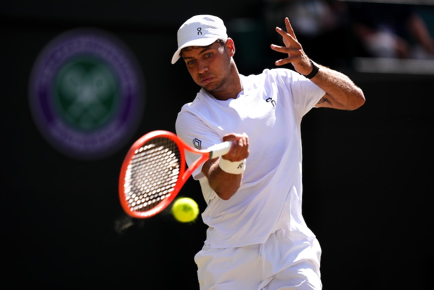 Flavio Cobolli hits a forehand at Wimbledon.