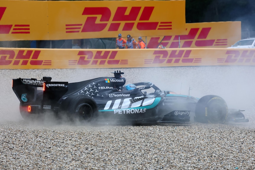 A racing car has smoke coming out of it