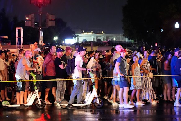 People wait to re-enter the National Mall after severe weather warnings prompted an evacuation.