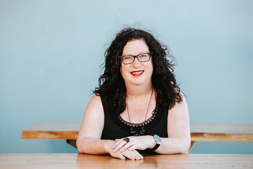 Woman sits at desk