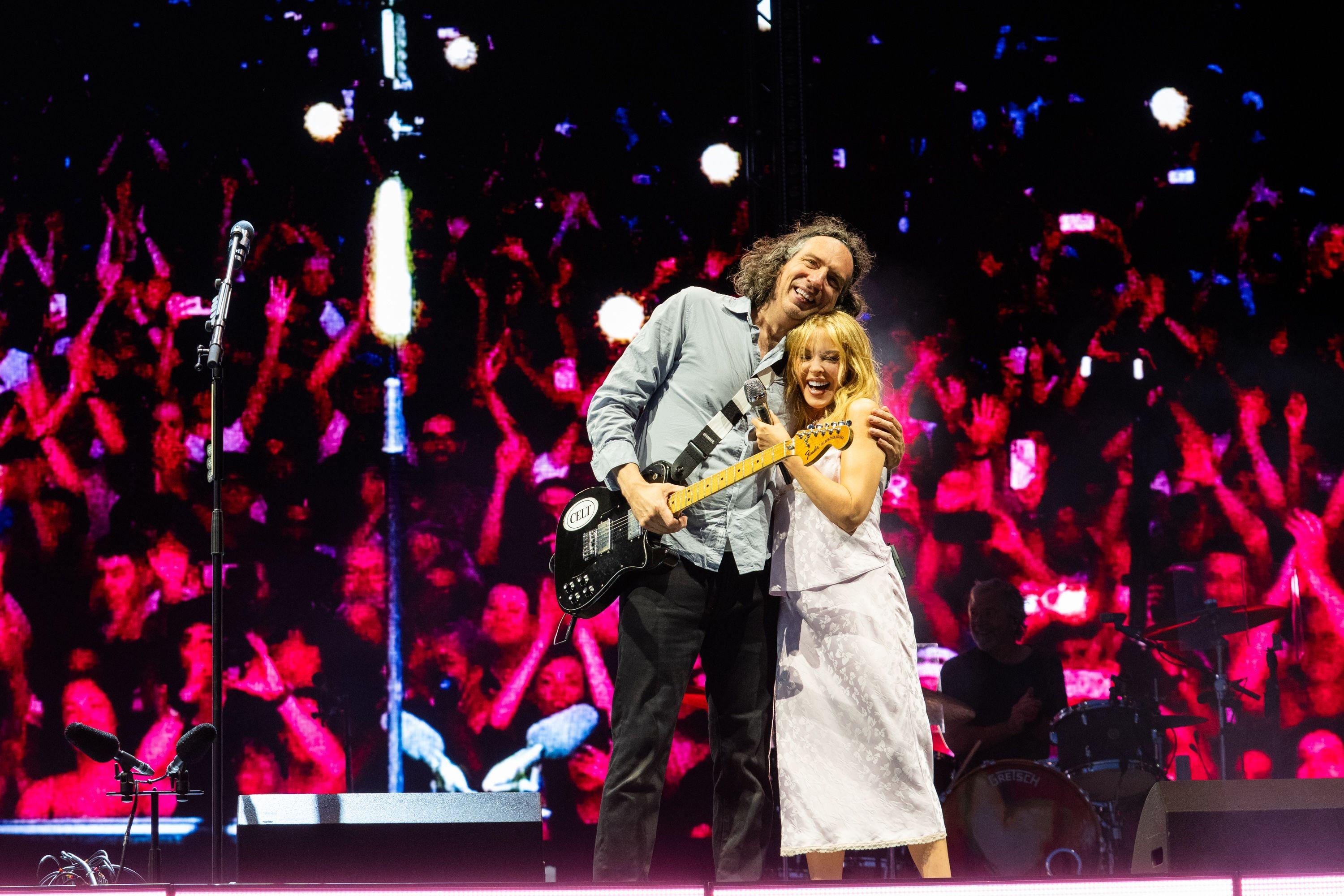 Kylie Minogue and Gary Lightbody hug on stage, after performing their song at Crystal Palace