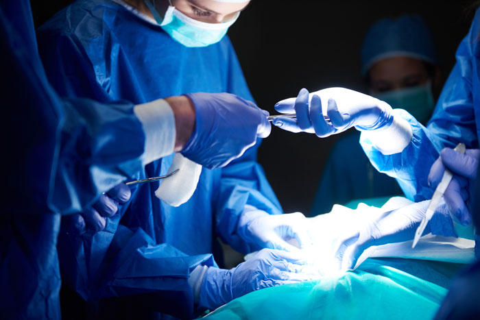 Medical workers performing surgery, revealing the intense and hidden side of hospitals and their procedures.