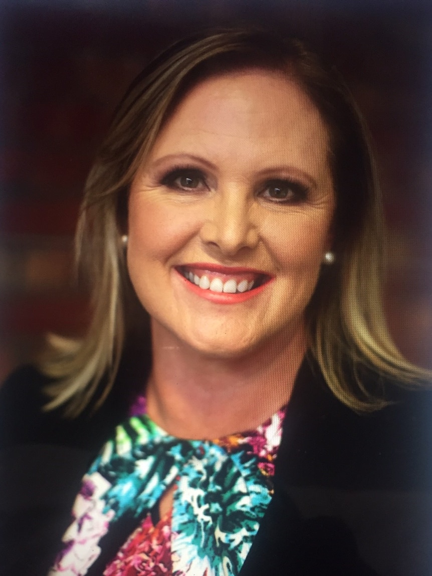 Headshot of woman smiling at camera.