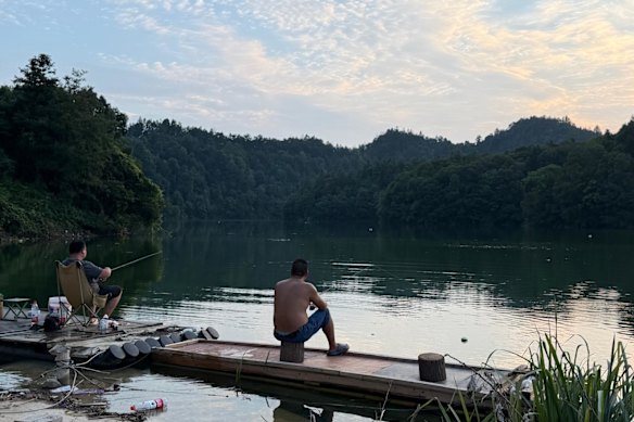 Villagers fish from the reservoir.