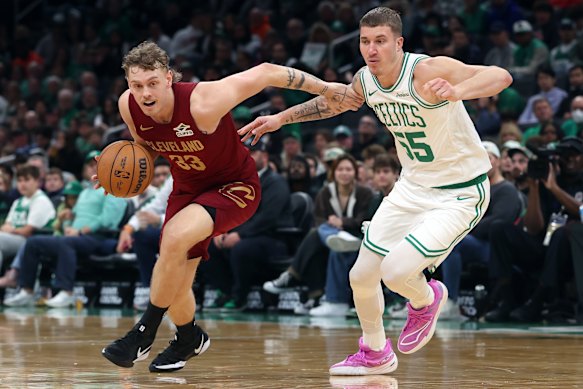 The Cleveland Cavaliers’ Luke Travers drives past Celtic Baylor Scheierman during an NBA pre-season game in 2025.