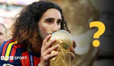 Marc Cucurella kissing the World Cup trophy