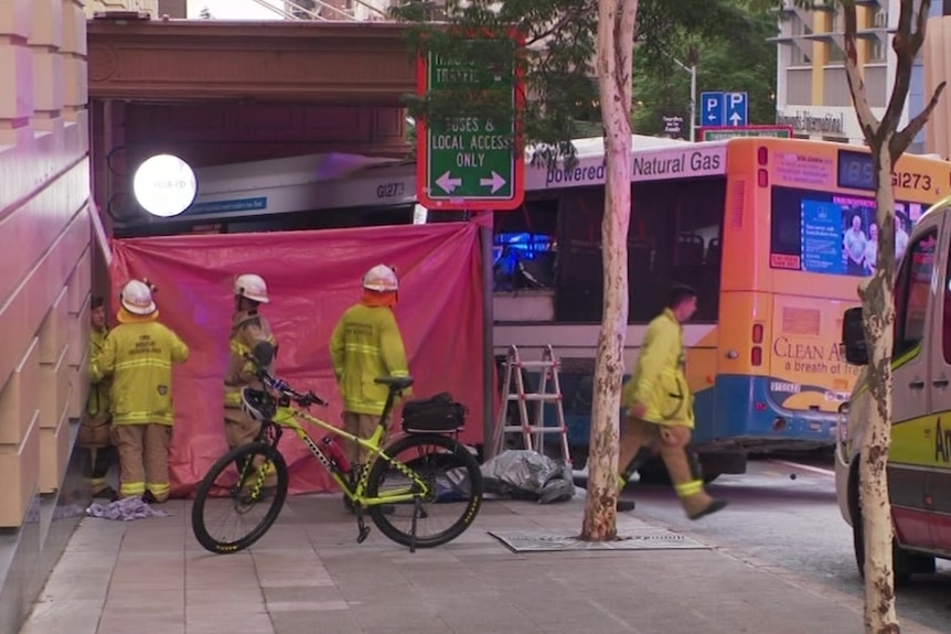 first responders secure a screen to block the crash scene
