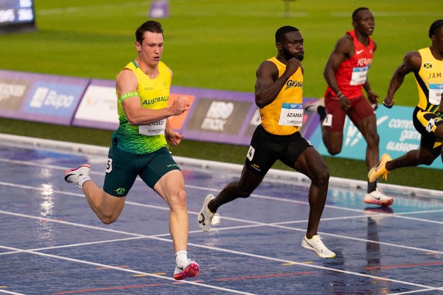Lachlan Kennedy in full flight against other athletes on the track