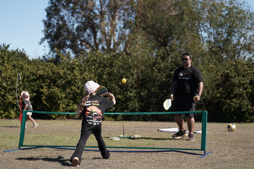 Supporters play pickleball outside the BHP operations during the strike.