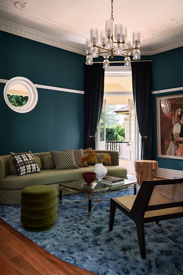 The curtains match the wall colour in this living room, which relies on a restrained palette and good natural light to live large.