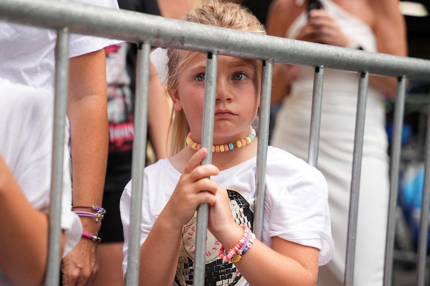 A child wearing a friendship bracelet for Taylor Swift wedding.