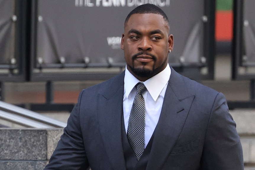 A man in a black suit.